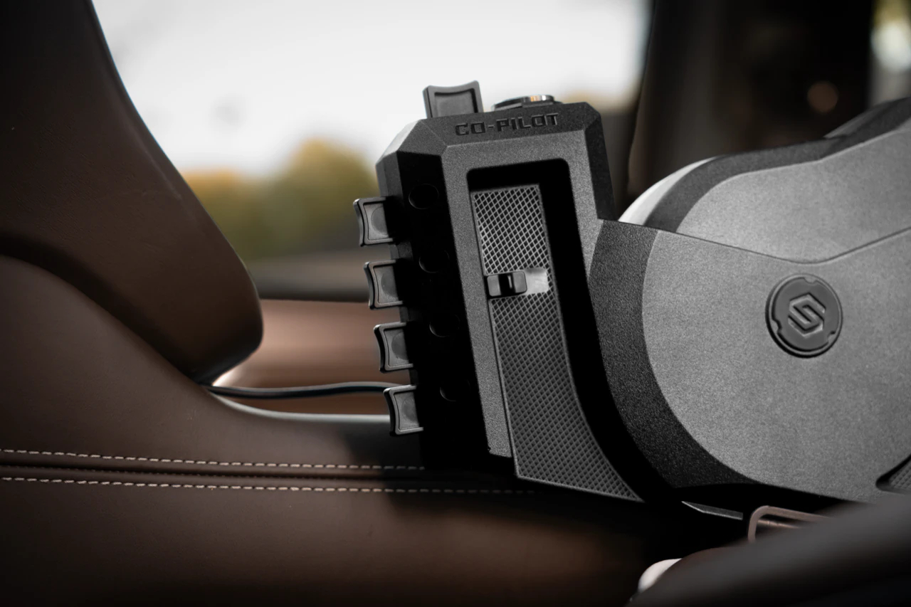 StopBox Co-Pilot installed beside the seat, with the hand-gesture buttons and security cable visible
