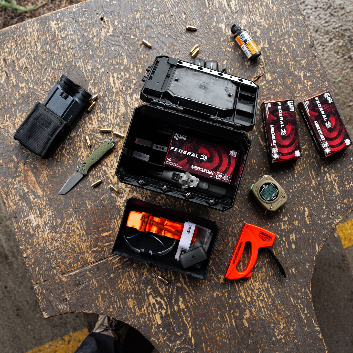 UCAN utility storage box with mechanical locking system organizing range gear and everyday carry items on table