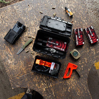 UCAN utility storage box with mechanical locking system organizing range gear and everyday carry items on table