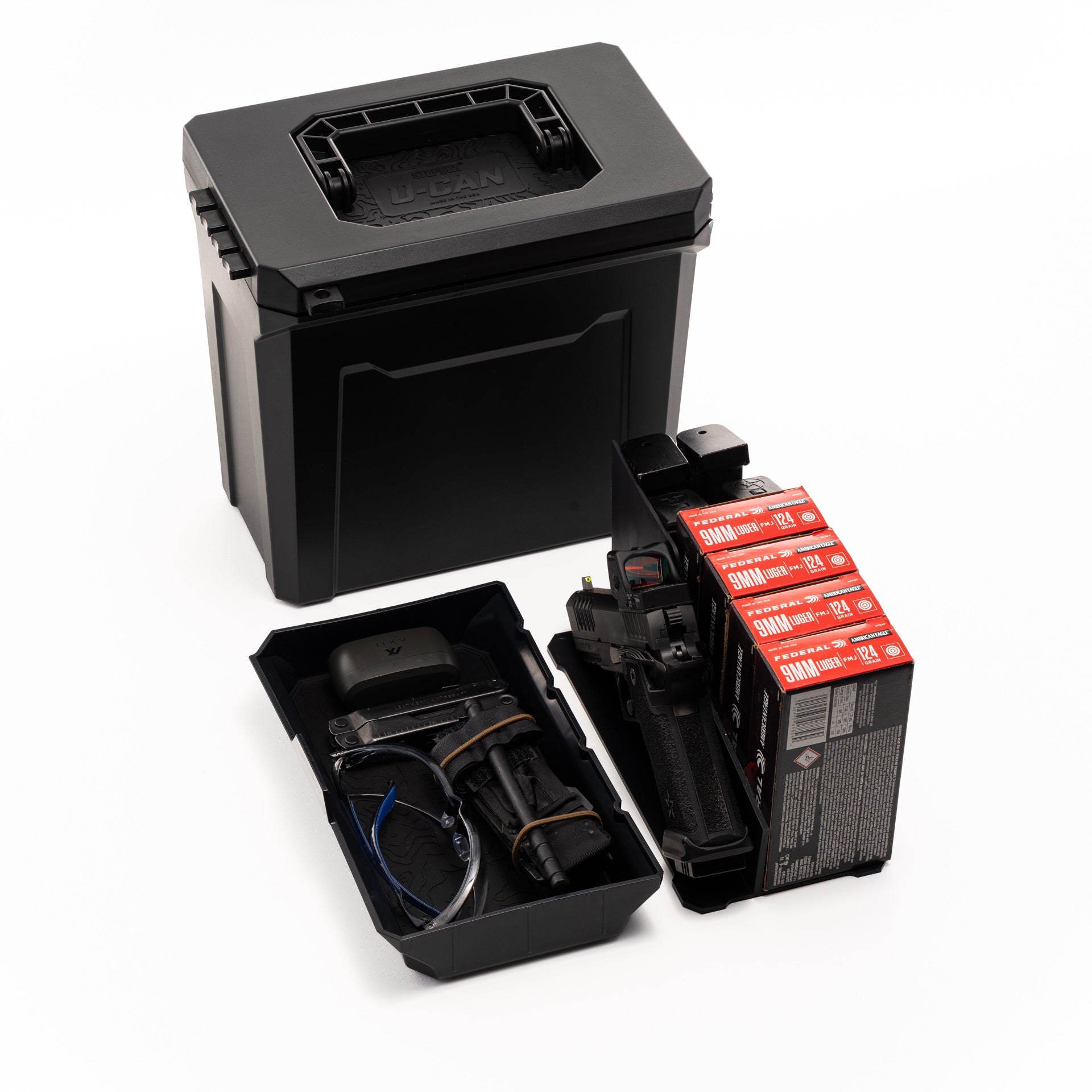 UCAN utility storage box with mechanical locking system organizing range gear and everyday carry items on table